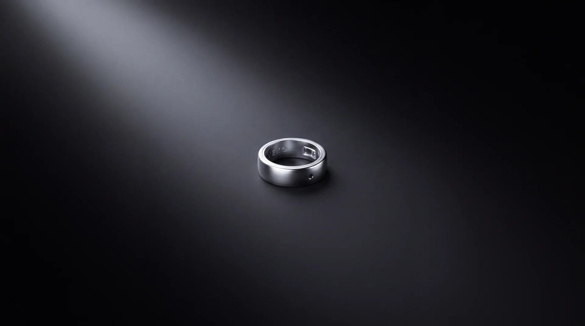 Vexo ring lit by a single spotlight against black